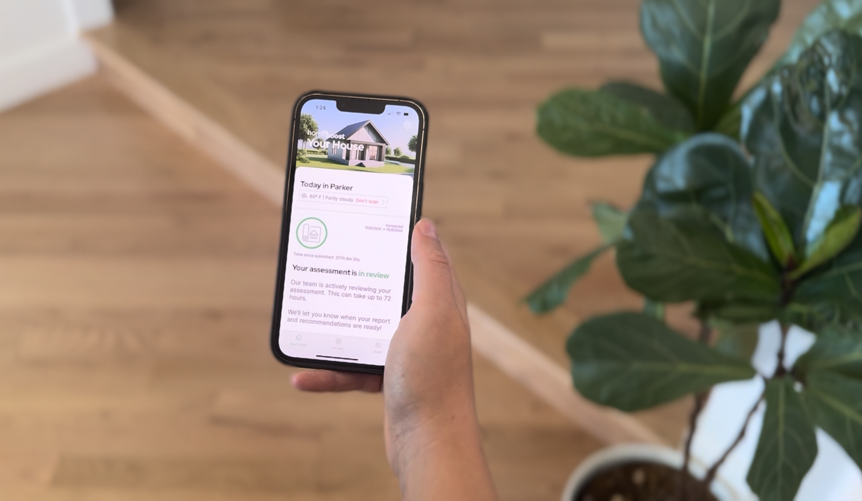 Phone in hand with HomeBoost App open and assessment in review